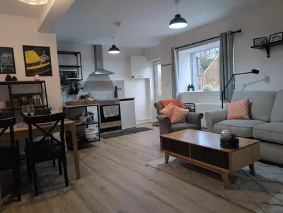 a living room with a couch and a table at Bryngwalia Fach in Cribyn