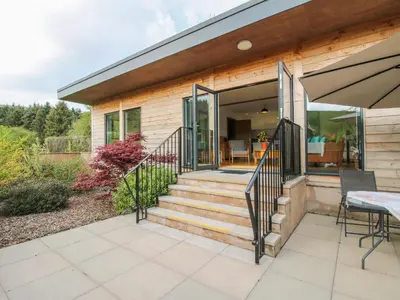 a home with sliding glass doors and a patio at No1 The Lodge in Bishops Castle