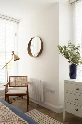 a bedroom with a mirror and a chair and a table at John Lewis Apartment in Aberaeron