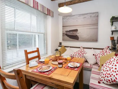 a dining room with a table with food on it at Bryniau Bychain Cottage in Machynlleth