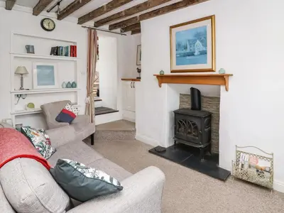 a living room with a couch and a fireplace at Bryniau Bychain Cottage in Machynlleth