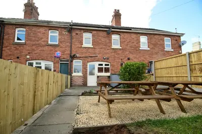 a picnic table in front of a brick building at Old Street Terrace in Ludlow
