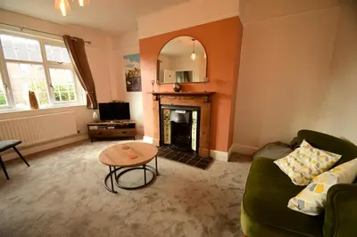 a living room with a couch and a fireplace at Old Street Terrace in Ludlow