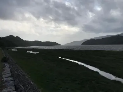 a large body of water with mountains in the background at Bryn Mair Gardens in Dolgellau