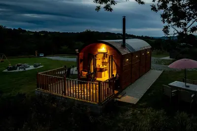 a small cabin in a yard with a light on at Blaenplwyf Shire Pods in Lampeter