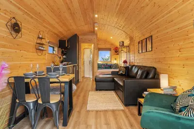 a living room with a couch and a table at Blaenplwyf Shire Pods in Lampeter