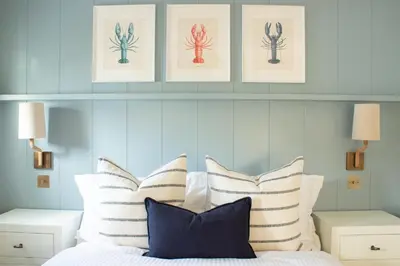 a bedroom with a bed with striped pillows at Richardson Apartment in Aberaeron