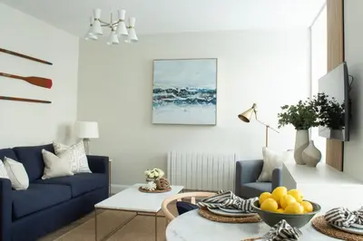 a living room with a blue couch and a table at Richardson Apartment in Aberaeron