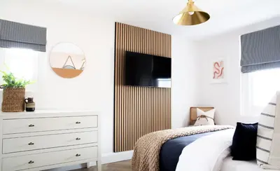 a bedroom with a bed and a dresser with a tv at Salthouse apartment in Aberaeron