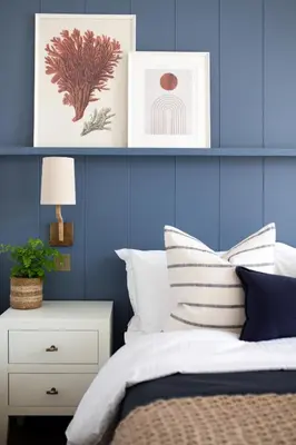 a bedroom with blue walls and a bed with white pillows at Morahan apartment in Aberaeron