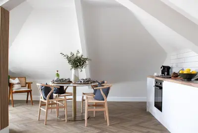 a dining room with a table and chairs at Morahan apartment in Aberaeron
