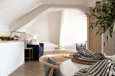 a living room with a table and a kitchen at Morahan apartment in Aberaeron