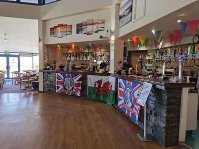 a bar with a counter with flags on it at Sea and Mountain view Sunbeach Holiday Snowdonia in Llwyngwril
