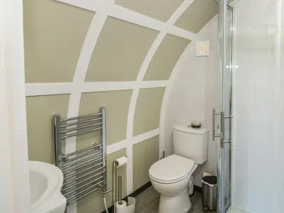 a bathroom with a toilet and a sink at Cherry Pod in Shrewsbury