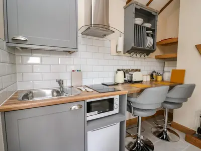 a small kitchen with a sink and a counter at The Old Cobblers Shop in Llandrindod Wells