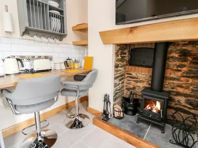 a fireplace in a kitchen with a stove at The Old Cobblers Shop in Llandrindod Wells