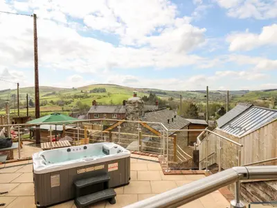 a hot tub on the roof of a house at The Old Cobblers Shop in Llandrindod Wells