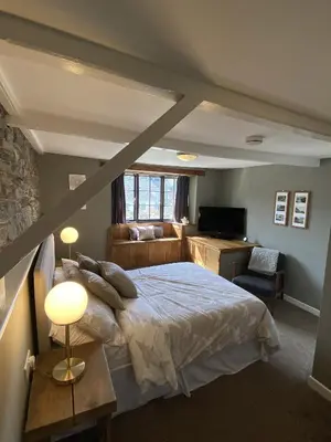 a bedroom with a bed and a couch and a desk at Tom's of Tregaron in Tregaron