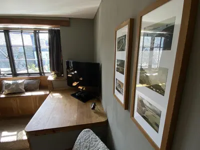 a living room with a television and a couch at Tom's of Tregaron in Tregaron