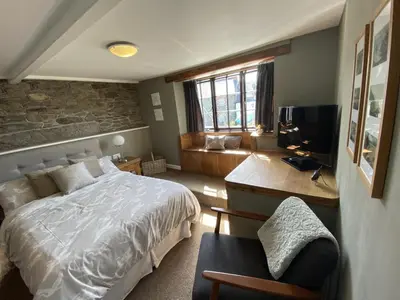 a bedroom with a bed and a desk and a couch at Tom's of Tregaron in Tregaron