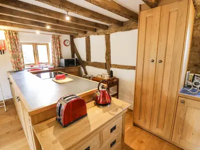 a kitchen with a tea kettle on a wooden counter at Manor Cottage in Church Stretton