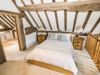 a bedroom with a bed and two night stands at Manor Cottage in Church Stretton