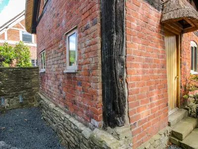 a brick building with a window on the side of it at Manor Cottage in Church Stretton