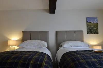 two beds sitting next to each other in a bedroom at The Cedars Ludlow in Lane to Richards Castle