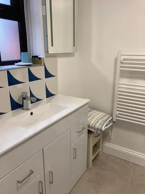 a white bathroom with a sink and a window at The Cedars Ludlow in Lane to Richards Castle
