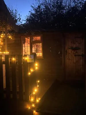 a house with lights in front of it at night at Four seasons with wood fuel hot tub Country retreat in Hereford