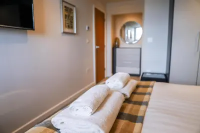 a hotel room with towels on a bed at Apartment Seven in Shrewsbury