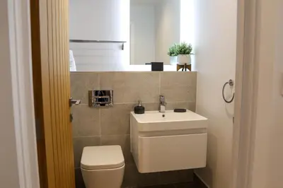 a bathroom with a white toilet and a sink at Apartment Seven in Shrewsbury