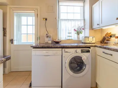 a kitchen with a washer and dryer at Turford House in Ludlow