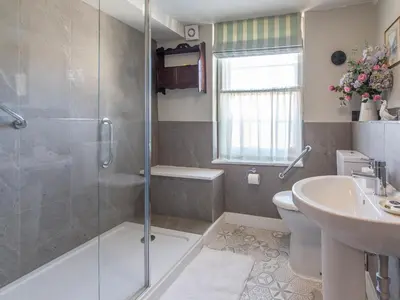 a bathroom with a shower and a toilet and a sink at Turford House in Ludlow