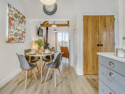a kitchen and dining room with a table and chairs at Mouse Croft - Uk33954 in Llanymynech