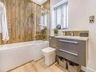 a bathroom with a tub and a toilet and a sink at Mouse Croft - Uk33954 in Llanymynech