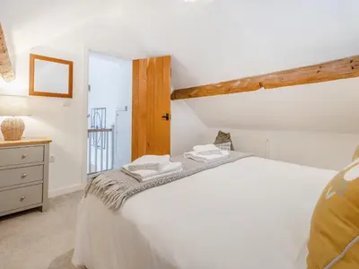 a bedroom with a white bed and a window at Pheasants Folly - Uk33955 in Llanymynech