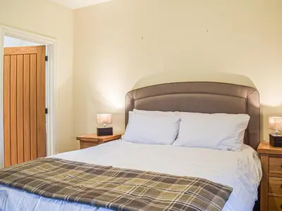 a bedroom with a bed with white sheets and pillows at Colstey Farmhouse in Acton