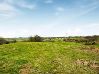 a field of green grass with a dirt road at Celyn Bach - Uk37083 in Llanwddyn