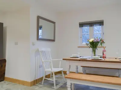 a dining room with a table and a mirror at Middle Hanter - Uk37355 in Old Radnor