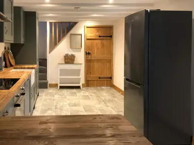 a kitchen with a black refrigerator and a staircase at Middle Hanter - Uk37355 in Old Radnor