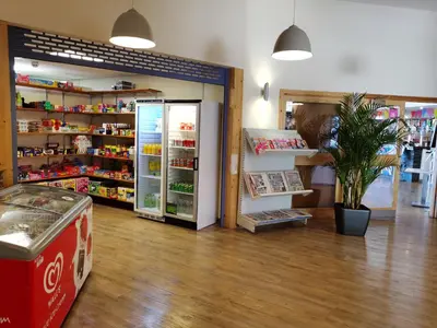 a store with a cocacola refrigerator in a room at Sea and Mountain view Sunbeach Holiday Snowdonia in Llwyngwril
