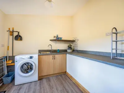 a kitchen with a washing machine and a sink at Horsecroft - Uk37462 in Dorstone
