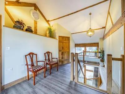 a dining room with two chairs and a table at Horsecroft - Uk37462 in Dorstone