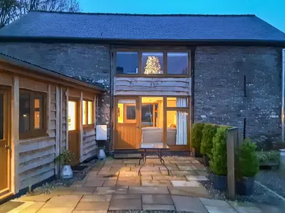 a cottage with a door and a patio at Horsecroft - Uk37462 in Dorstone