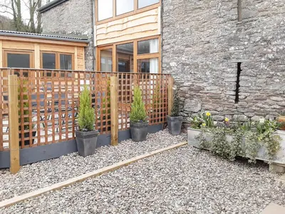 a fence with potted plants in front of a building at Horsecroft - Uk37462 in Dorstone