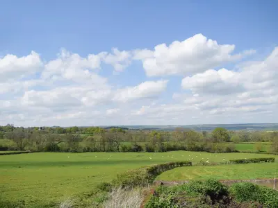 a large green field with sheep grazing in it at Horsecroft - Uk37462 in Dorstone