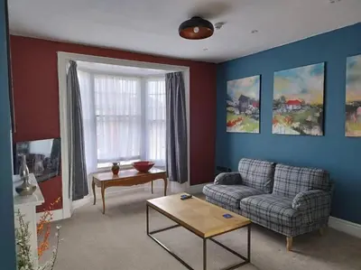 a living room with a couch and a table at Apartment 2, Aberystwyth Town Centre in Aberystwyth