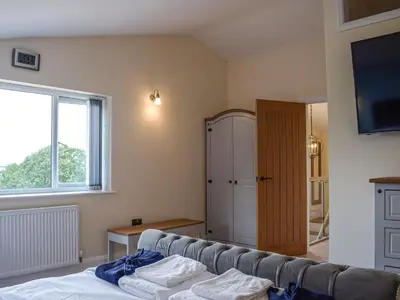 a living room with a couch and a window at The Lookout - Uk35022 in Hope under Dinmore