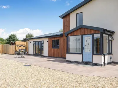 a house with glass doors and a patio at The Lookout - Uk35022 in Hope under Dinmore